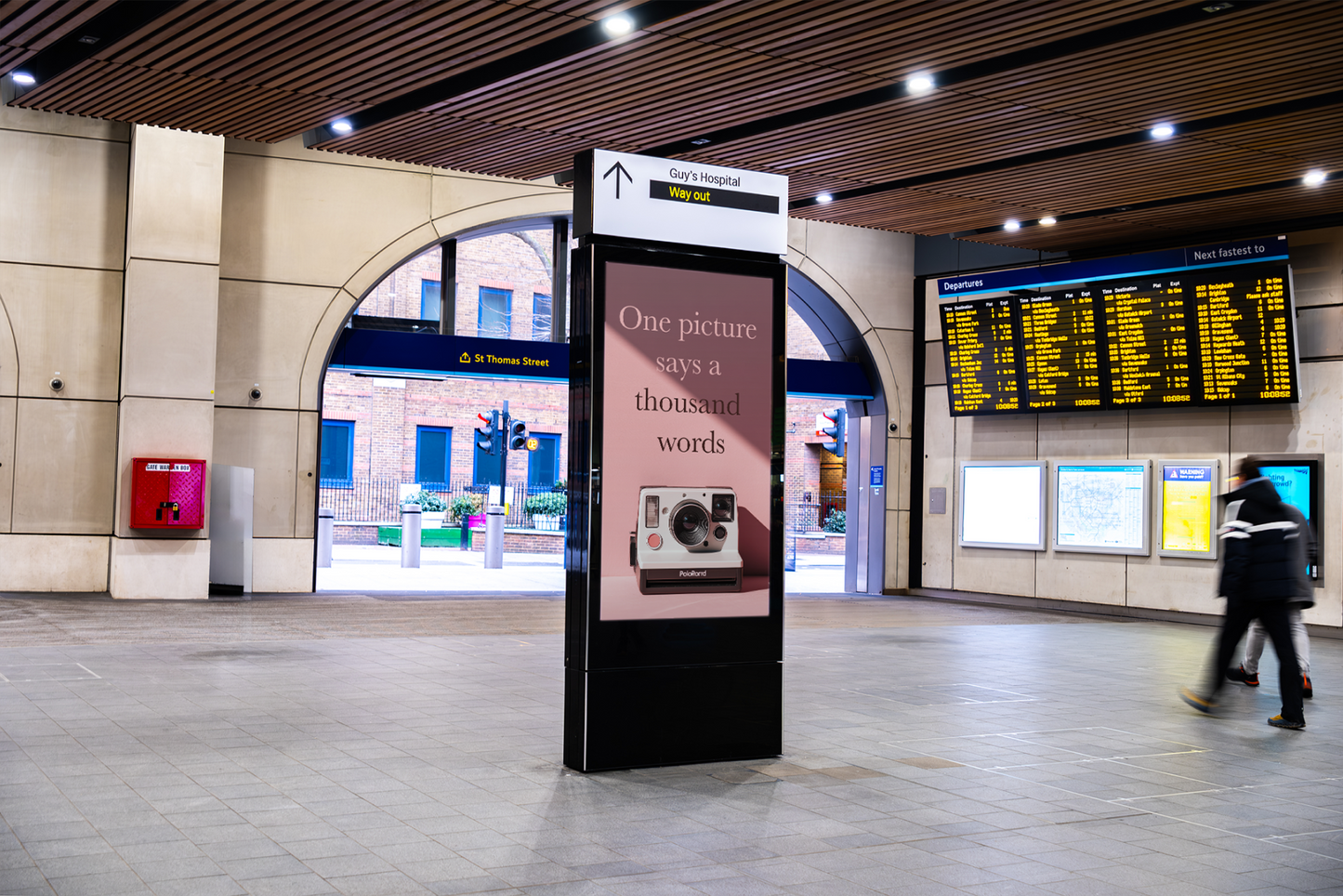 Digital display in a train station with a message about photography.