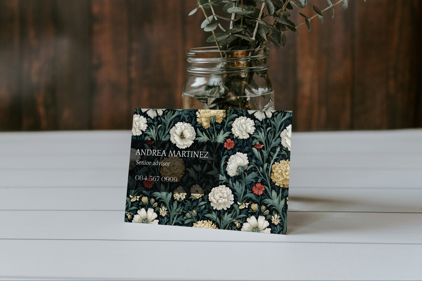 Floral business card on a wooden surface with a blurred background