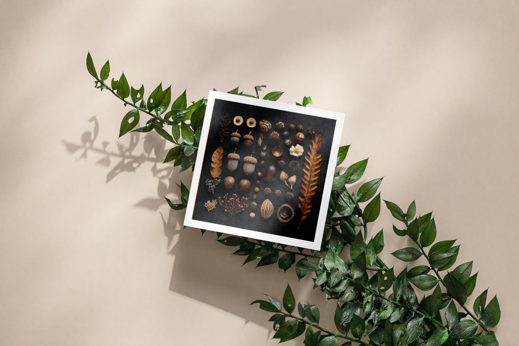 Framed artwork with nature-themed elements on a beige background with green leaves.