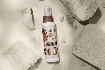 Skincare bottle with natural ingredients on a textured stone background