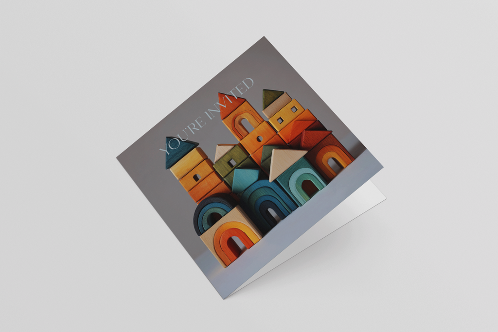 Colorful paper sculpture of a town in a box on a light gray background