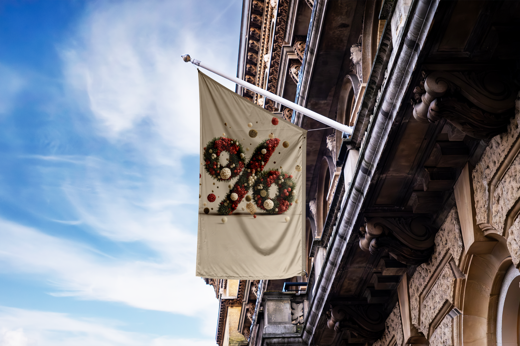Decorative flag with floral design on a building facade against a blue sky.