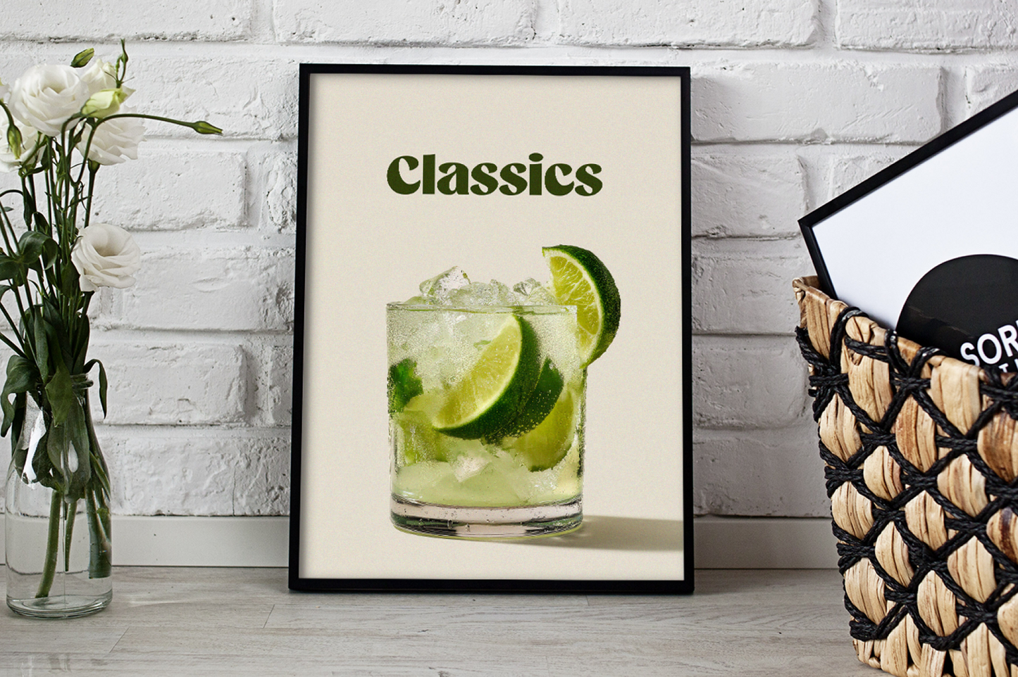 Framed print of a cocktail with lime slices on a white brick wall background