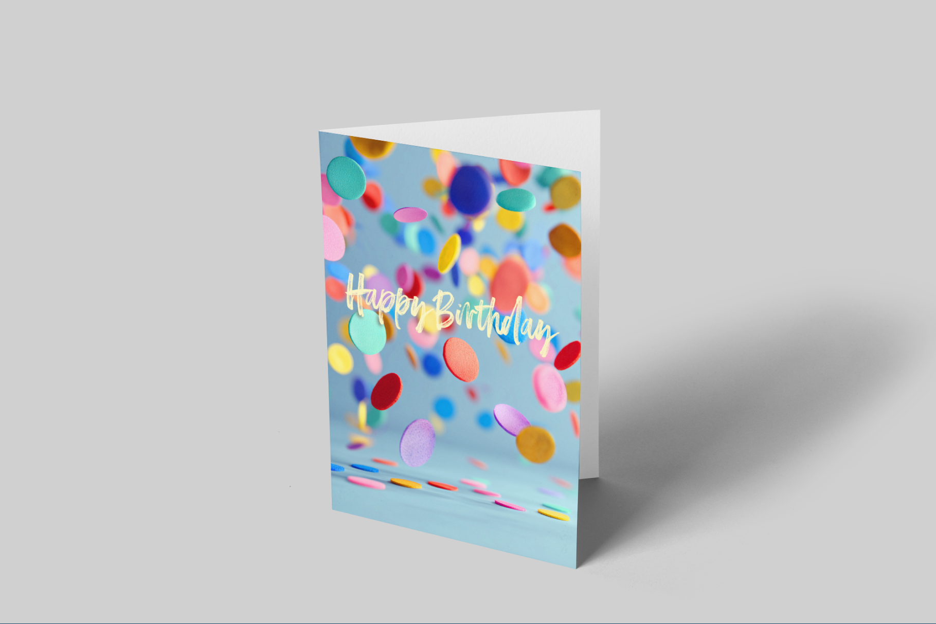 Colorful birthday card with confetti design on a gray background
