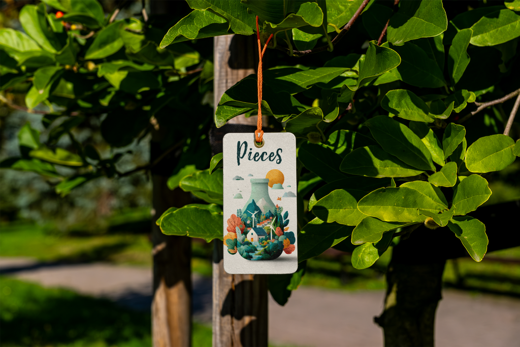 Decorative tag with 'Pieces' design hanging from a tree