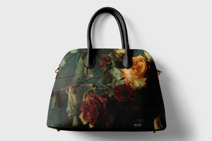 Floral patterned handbag with black handle on a light gray background