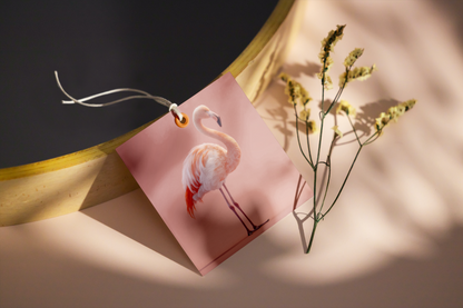 Greeting card with flamingo design on a soft surface with plants