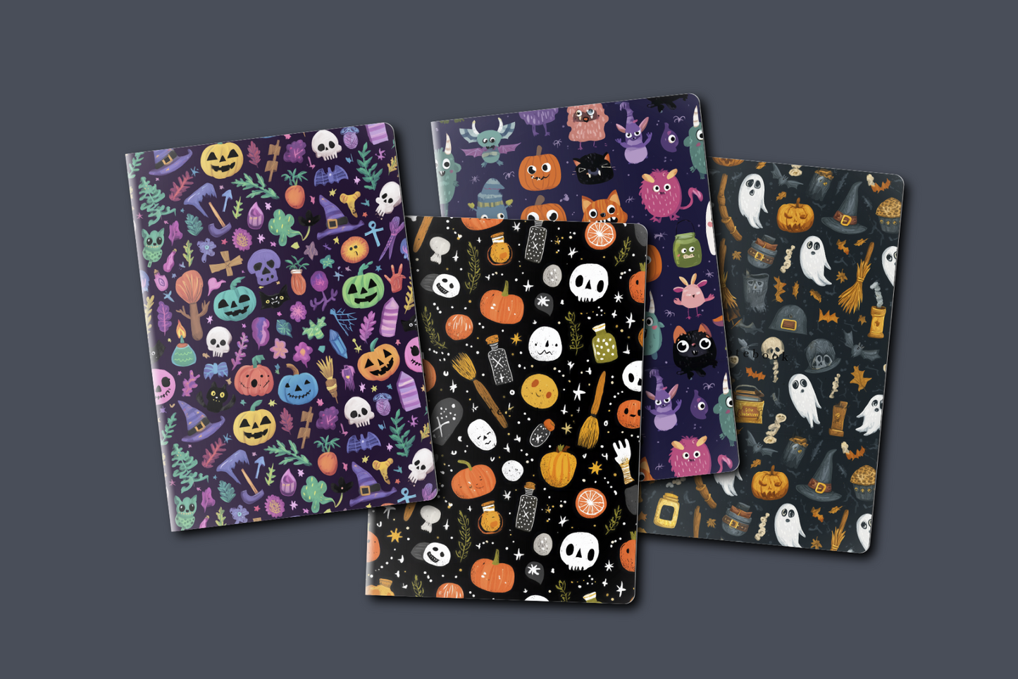Four Halloween-themed notebooks with colorful designs on a dark gray background