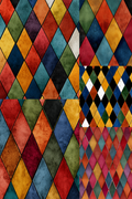 A multicolor harlequin diamond pattern collage with textured diamond tiles in red, orange, yellow, blue, green, black, and white, arranged in a grid with a smaller patterned panel on the right.