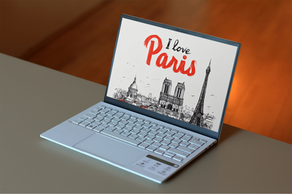 Laptop with 'I love Paris' screen on a wooden surface