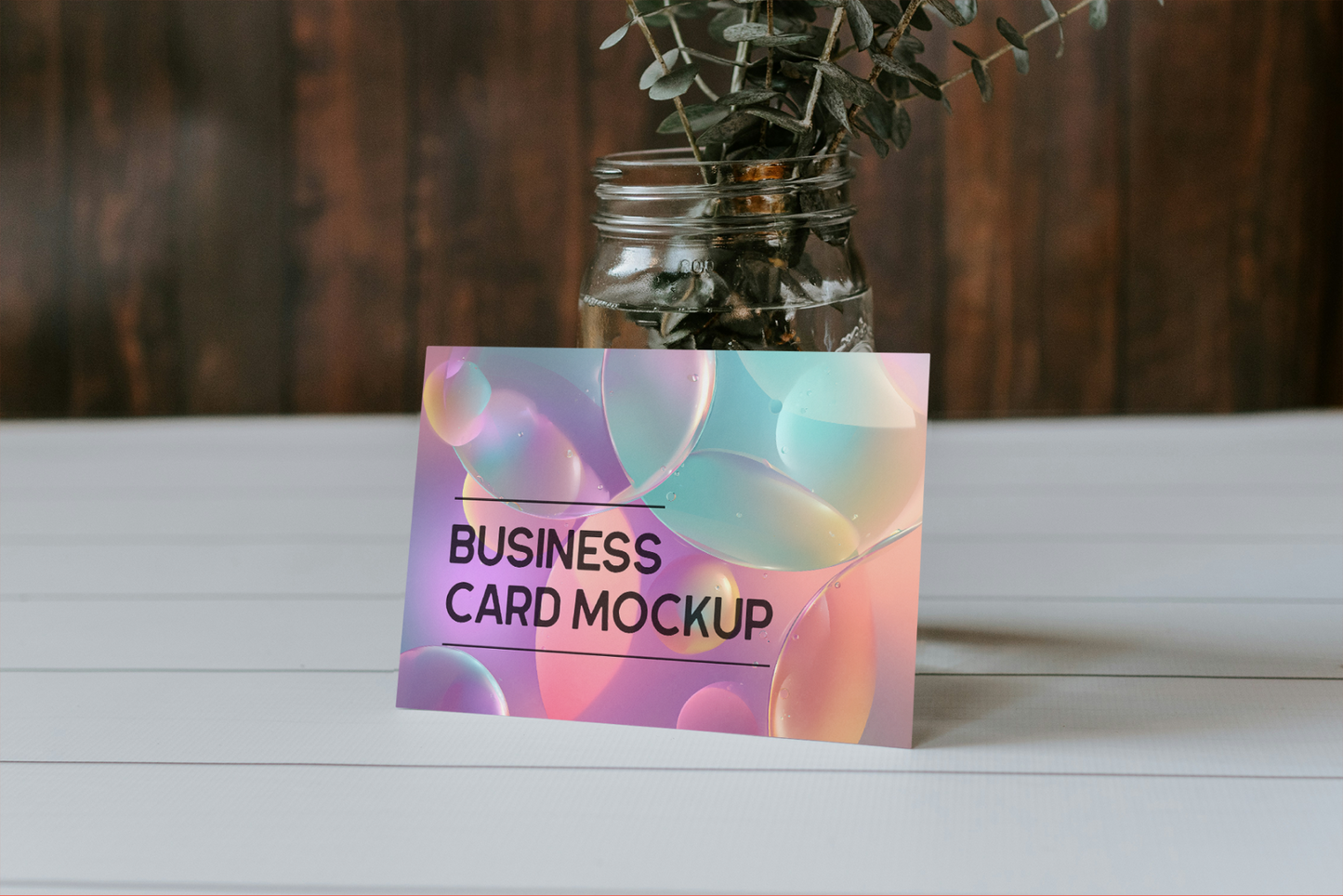 Business card mockup with a colorful design on a wooden surface