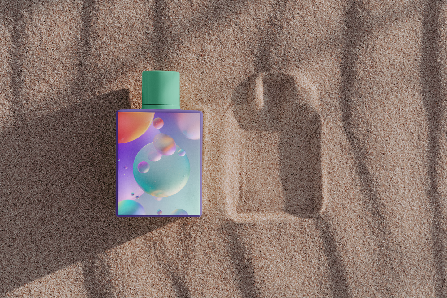 Perfume bottle with colorful label on sand
