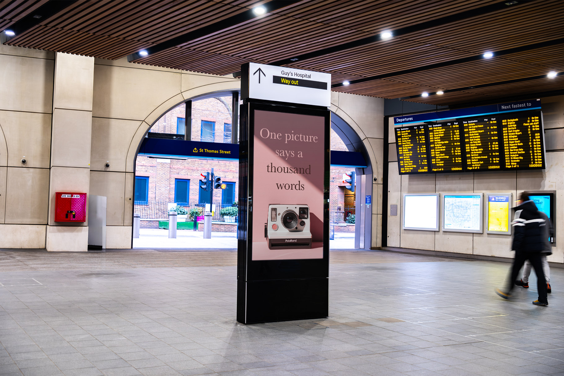 Digital display in a train station with a message about photography.