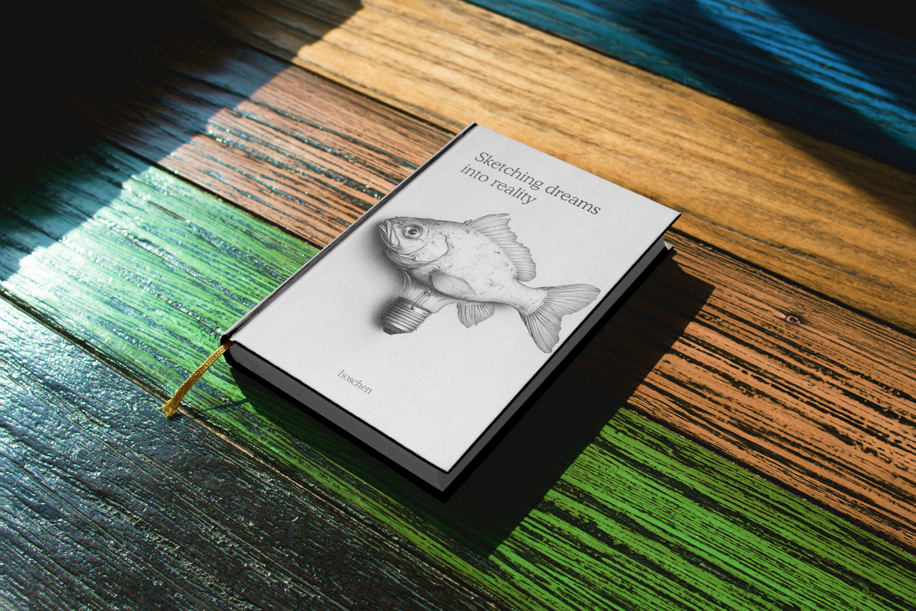 Notebook with fish illustration on a wooden surface