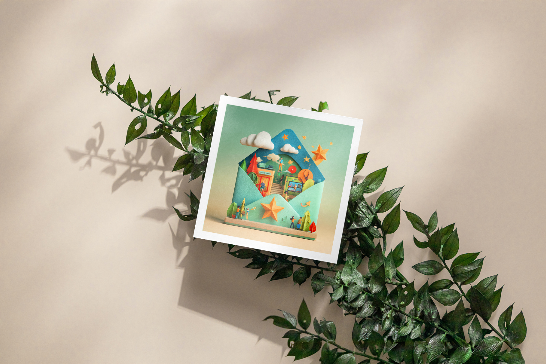 Framed artwork with a colorful design of a house, clouds, and plants, surrounded by green leaves on a beige background.