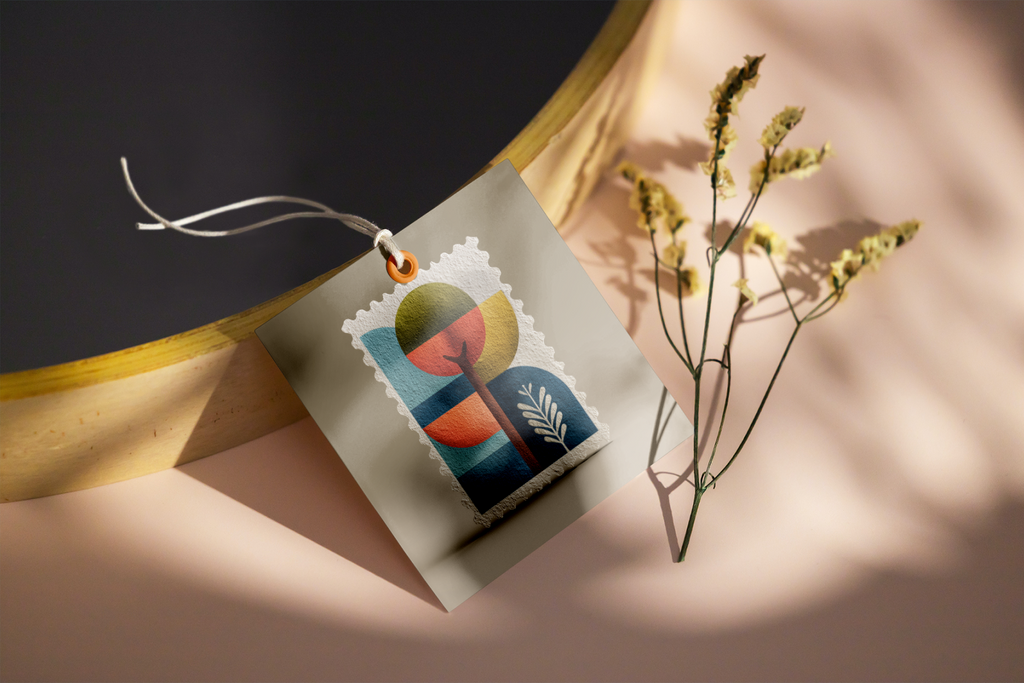 Colorful book-shaped object on a white card with a plant in the background