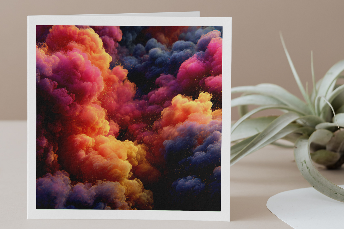 Colorful cloud-themed greeting card on a wooden surface with a plant.