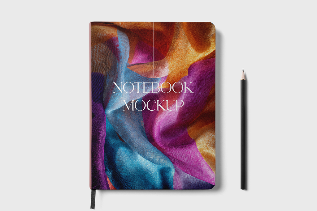 A notebook mockup with an abstract multicolor cover design featuring purple, blue, orange, and red flowing shapes, with the text 'NOTEBOOK MOCKUP' printed on the front. A black pencil stands to the right on a light gray background.