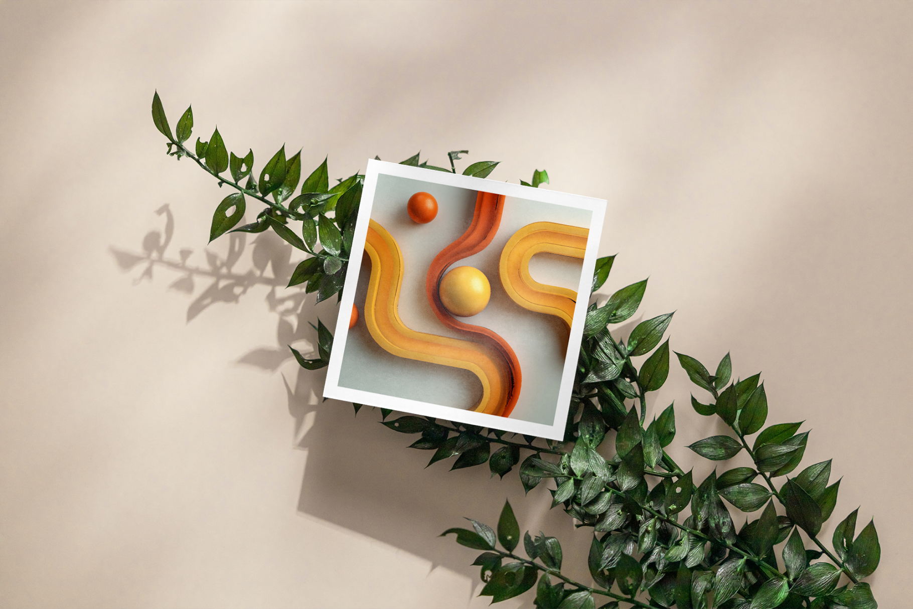 Framed artwork with abstract design of wavy lines and spheres, surrounded by green leaves on a beige background.