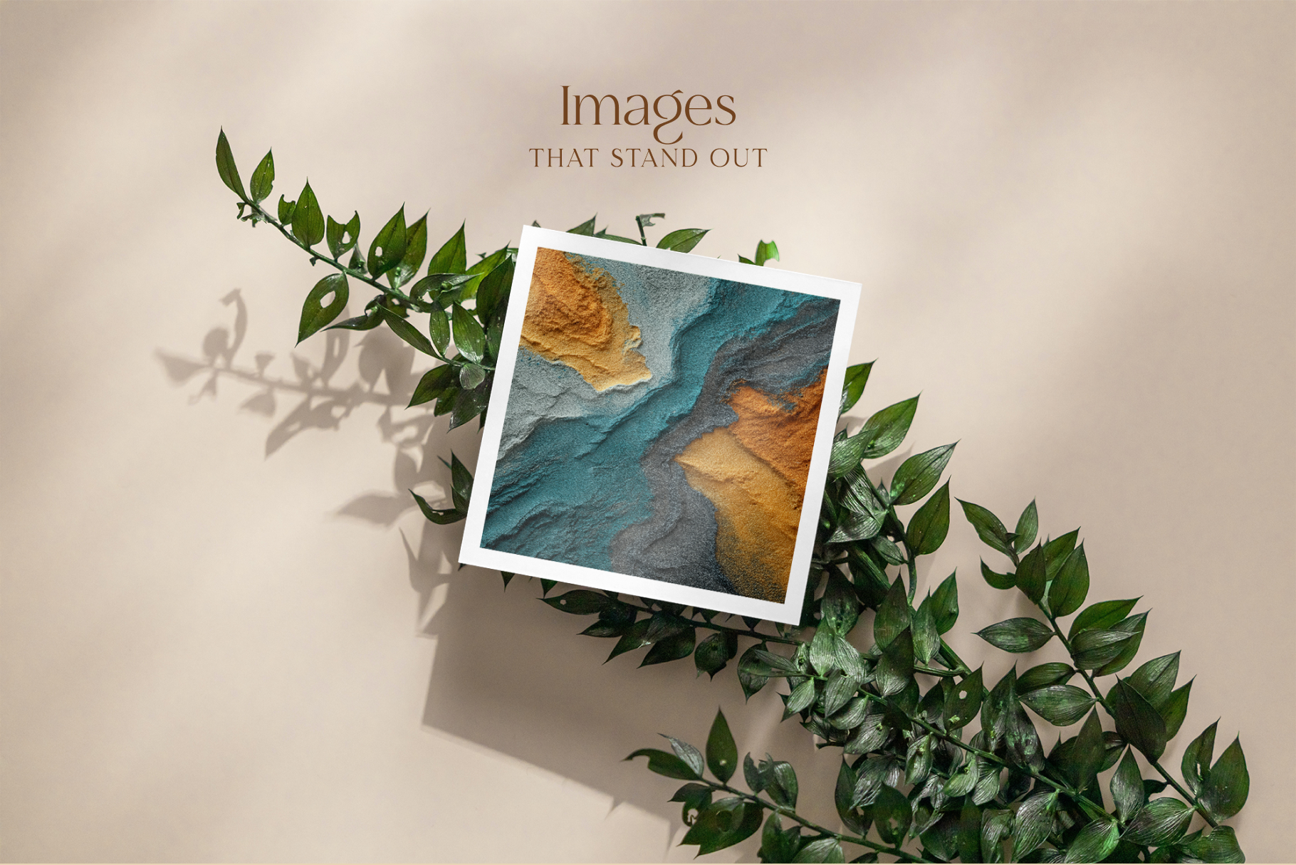 Framed artwork with a landscape design on a beige background with green leaves.