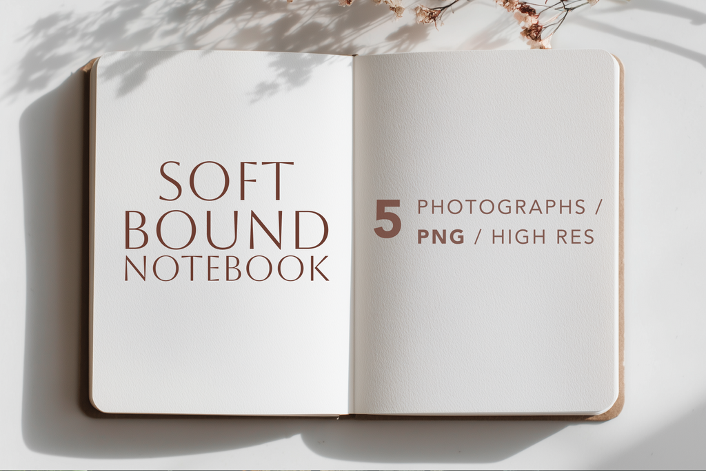 An open notebook mockup on a white surface with soft shadows and dried flowers at the top. The left page reads 'SOFT BOUND NOTEBOOK' and the right page reads '5 PHOTOGRAPHS / PNG / HIGH RES'.