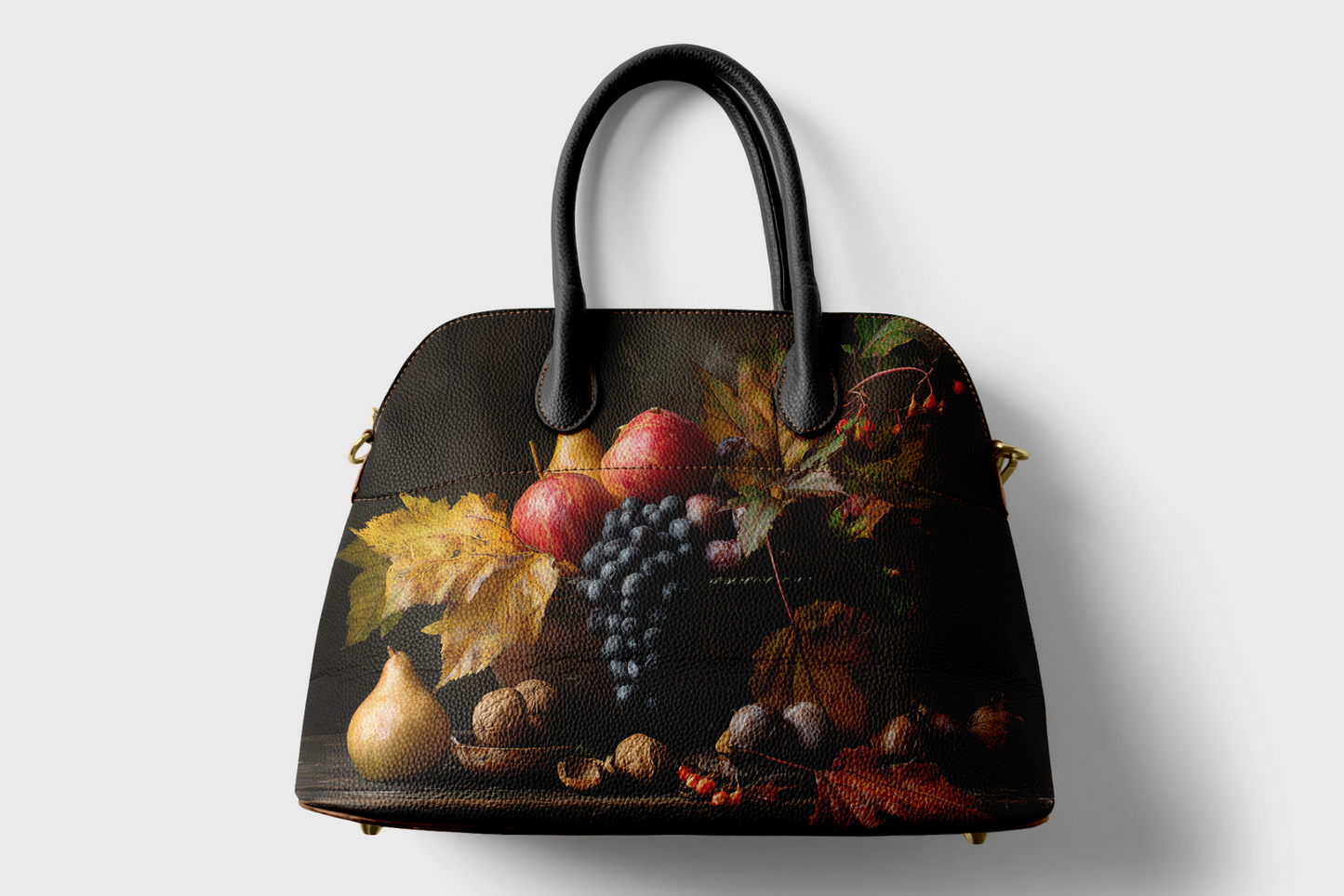Handbag with a still life design of fruits and leaves on a white background