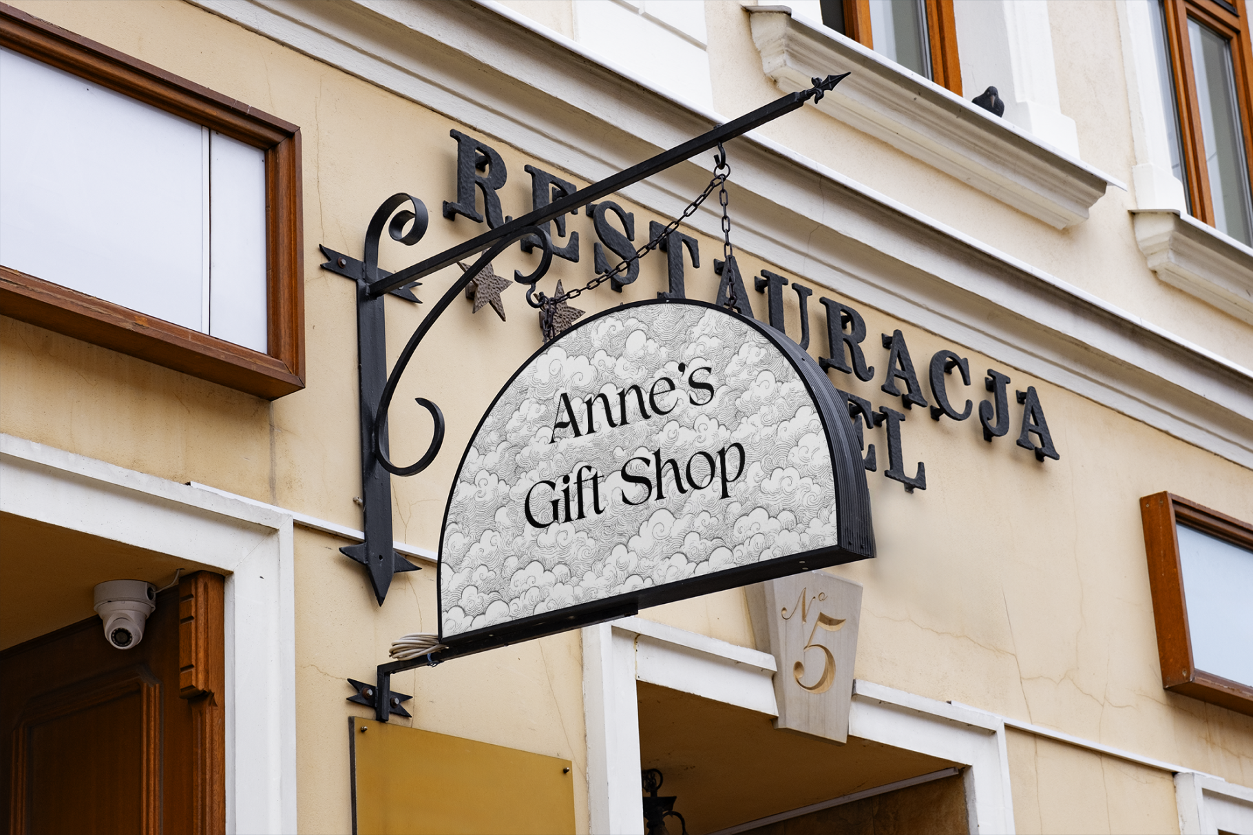 Sign for Anne's Gift Shop on a building facade with 'Restauracja' above it.