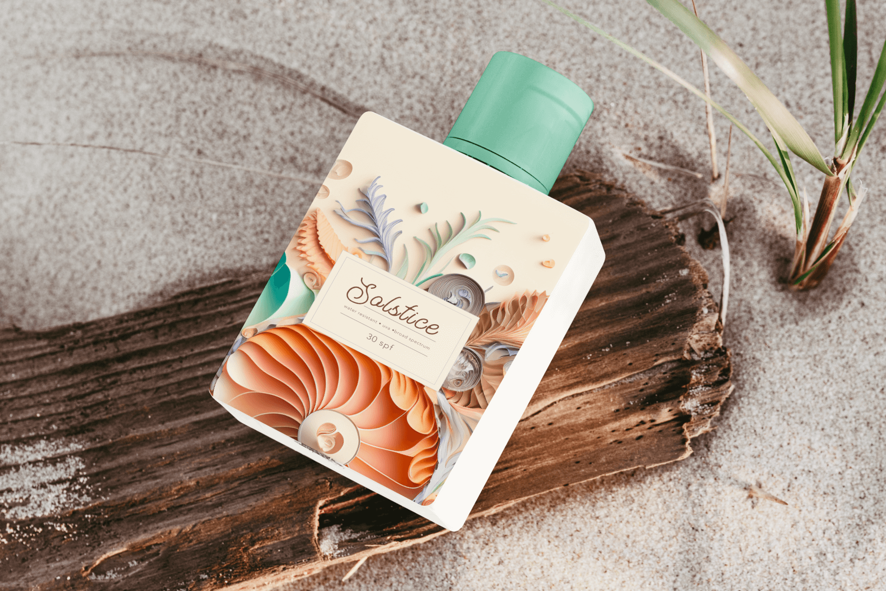 A photograph of a lotion bottle laying on a log on a sandy beach. The packaging is an seashell composition made with paper quilling technique.