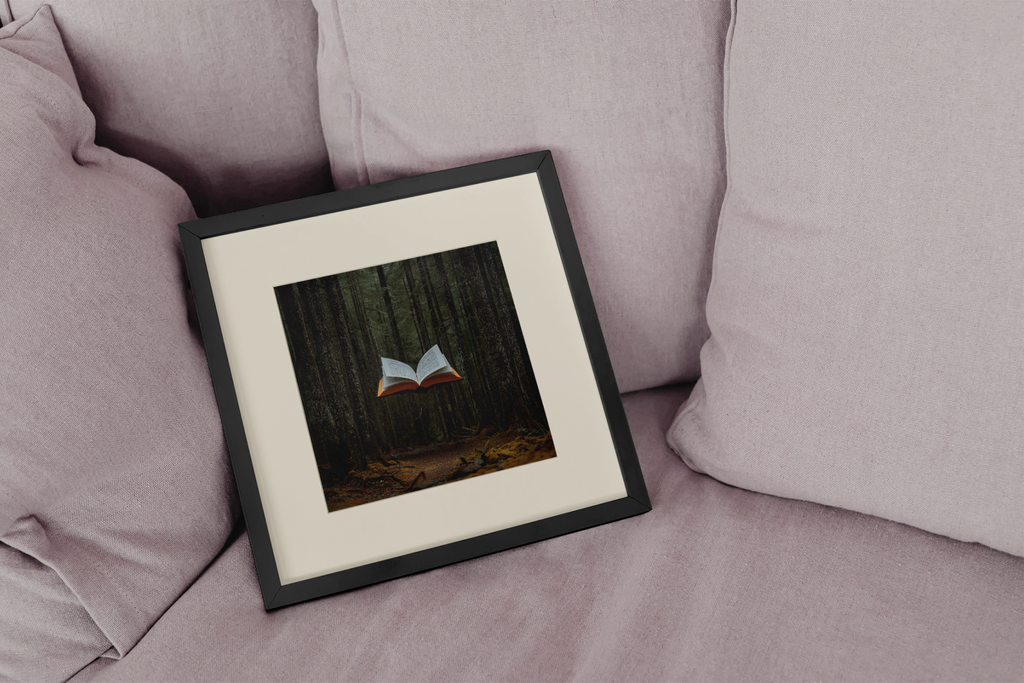 Framed artwork of a book in a forest on a pink couch