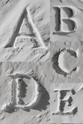 letters A, B, C, D, and E on a snowy surface