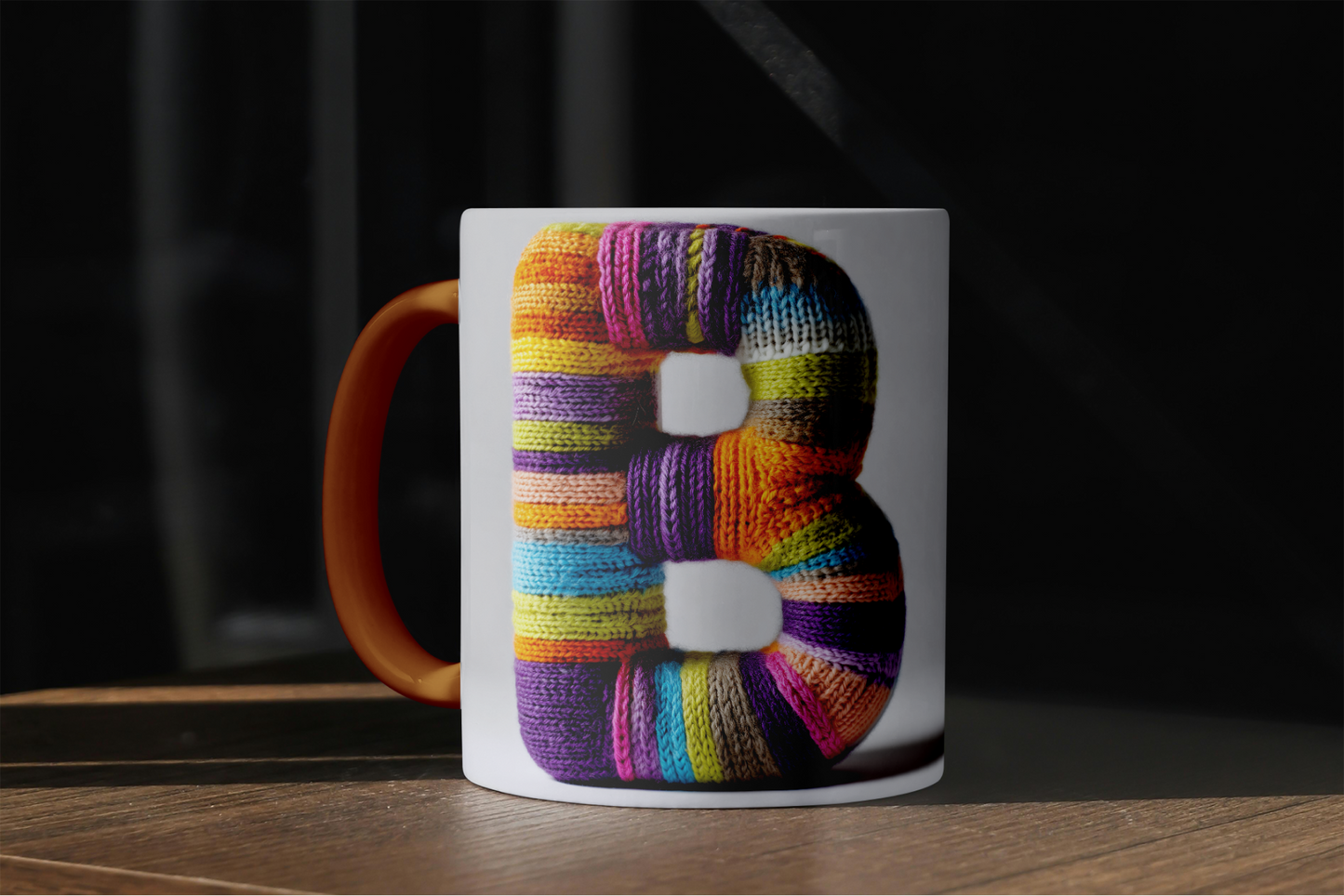 Mug with a colorful letter 'B' design on a wooden surface.
