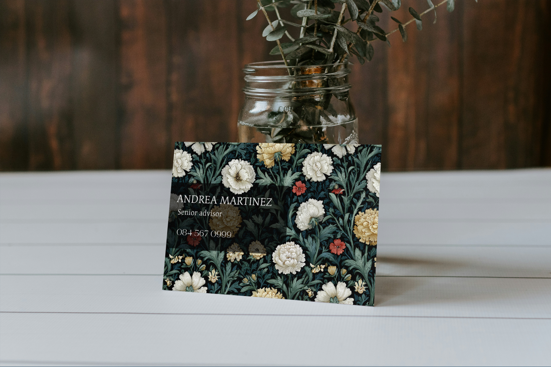 Floral business card on a wooden surface with a blurred background
