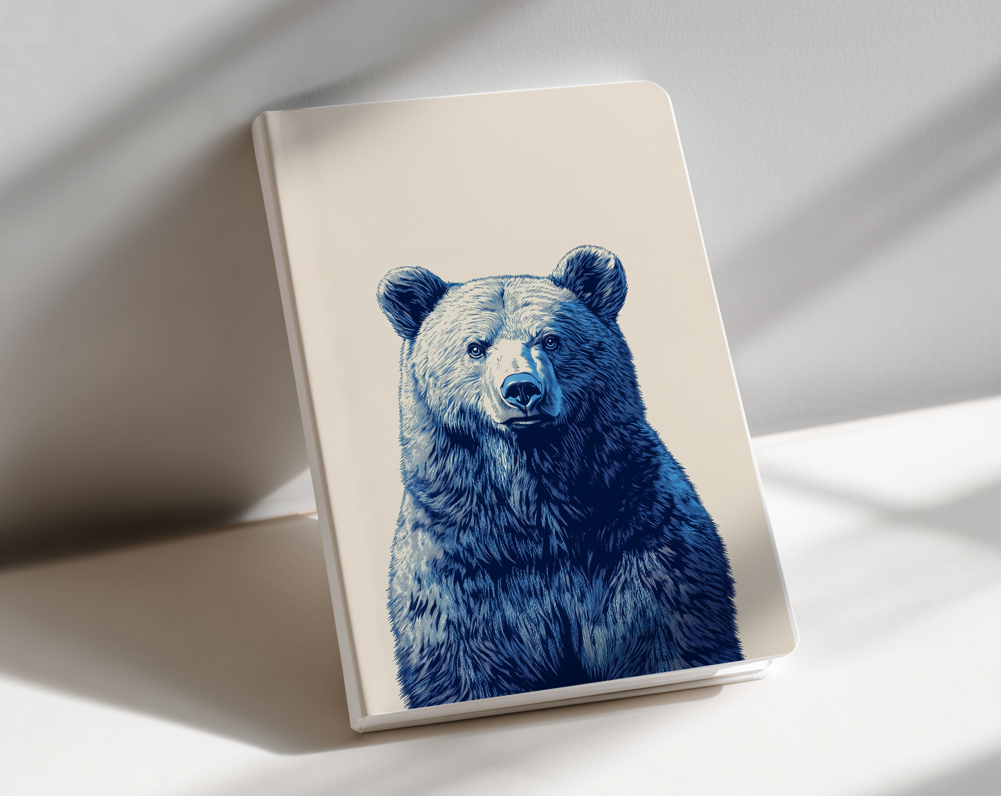 Notebook with a blue bear illustration on a white surface