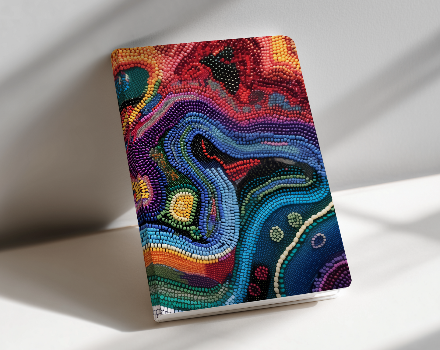 Colorful abstract design notebook on a white surface