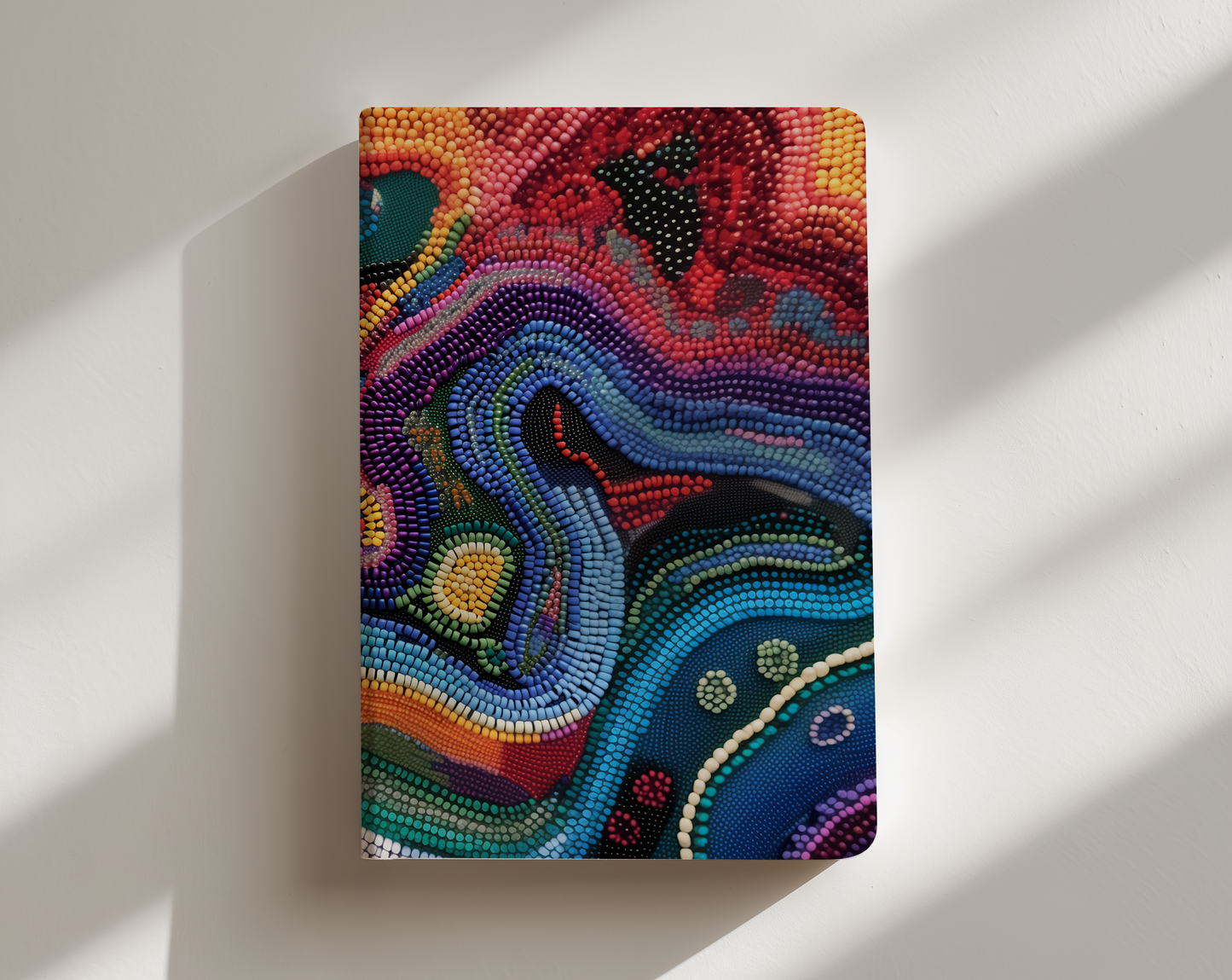 Colorful abstract patterned notebook on a white background