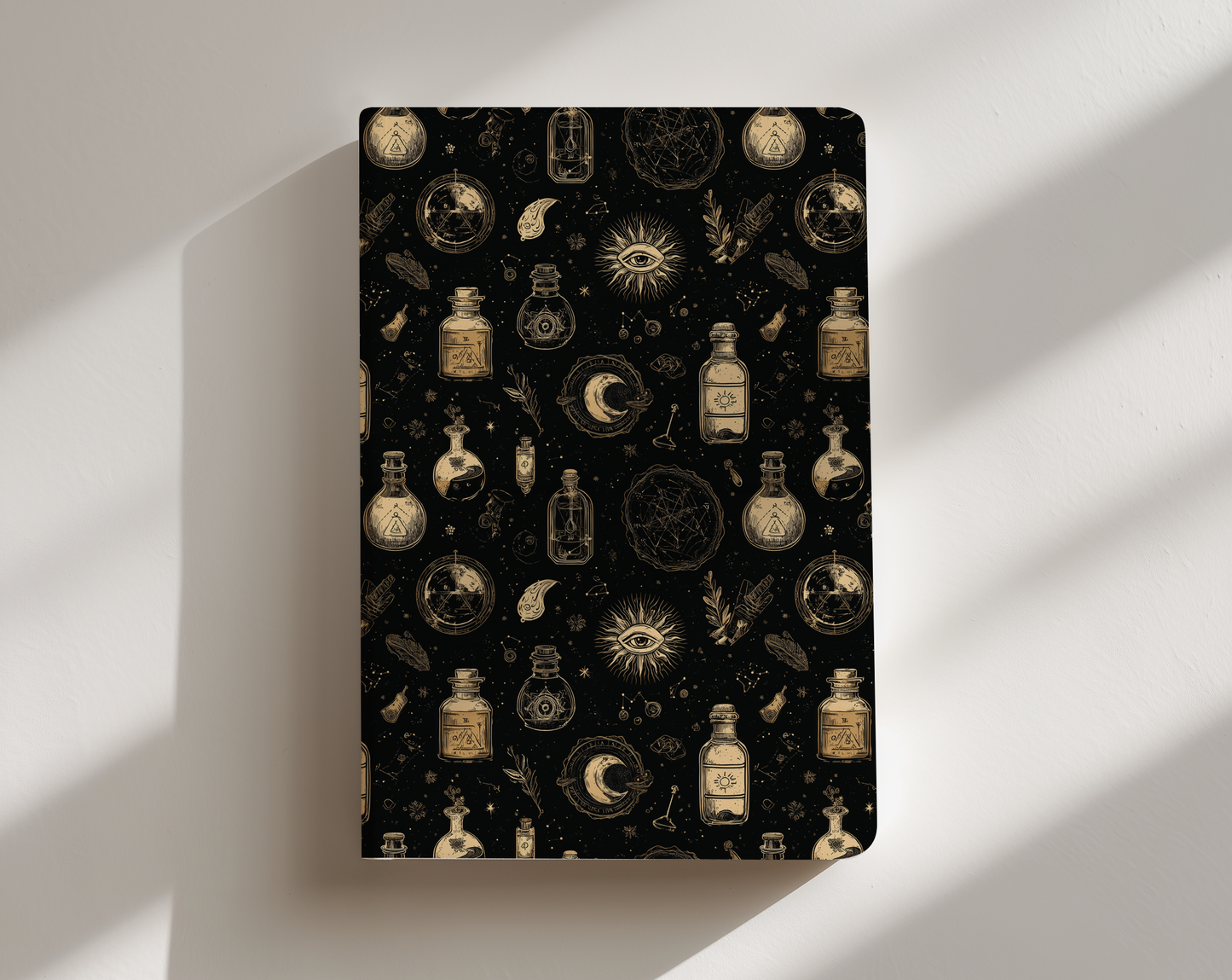 Notebook with alchemical symbols and bottles on a black background