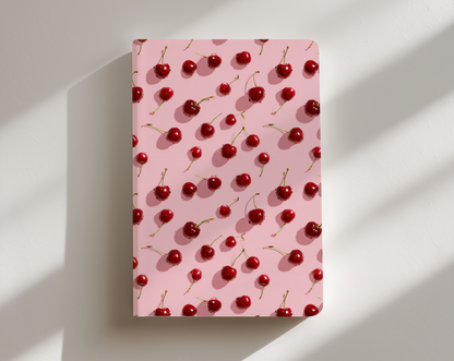 Notebook with cherry pattern on a pink cover against a white background
